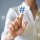 person touches hashtag icon