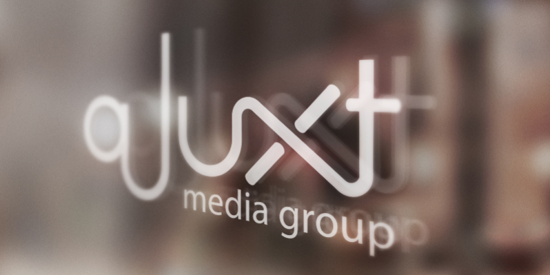 Text: "aJuxt Media Group" etched onto a glass door