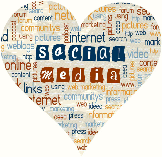 A heart shape filled with various buzz words for social media/community/internet with "social media" in the center