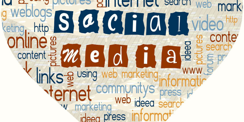 A heart shape filled with various buzz words for social media/community/internet with "social media" in the center