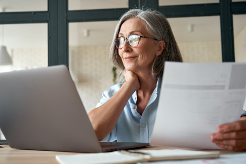 Smiling Mature Middle Aged Business Woman Working on Laptop