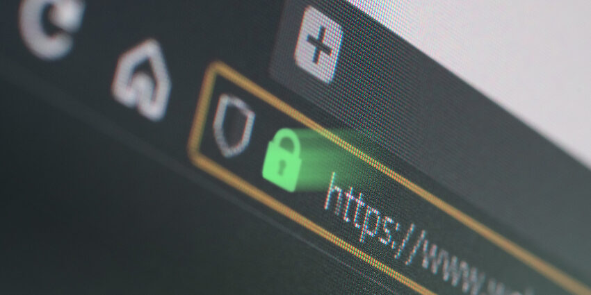 Dark web browser close-up on LCD screen with shallow focus, light shining through https padlock. Internet security, SSL certificate, cybersecurity, search engine and web browser concepts