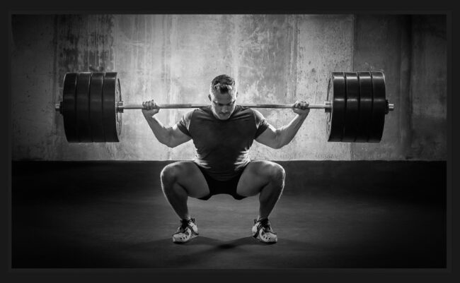 professional photography example: a man weightlifting; black & white photo