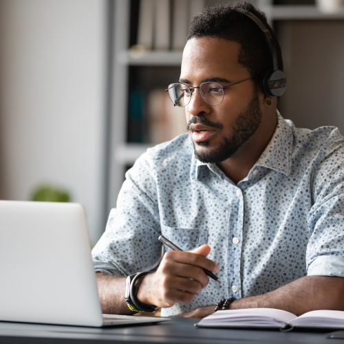 Focused African Businessman Wear Headphones Study Online