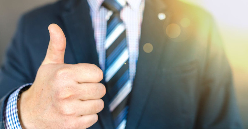 Man in business suit giving a thumbs up