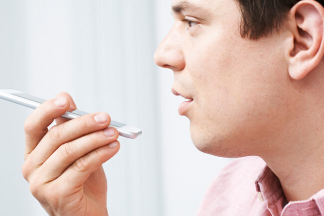 Man Using Internet Voice Search Technology On Mobile Phone