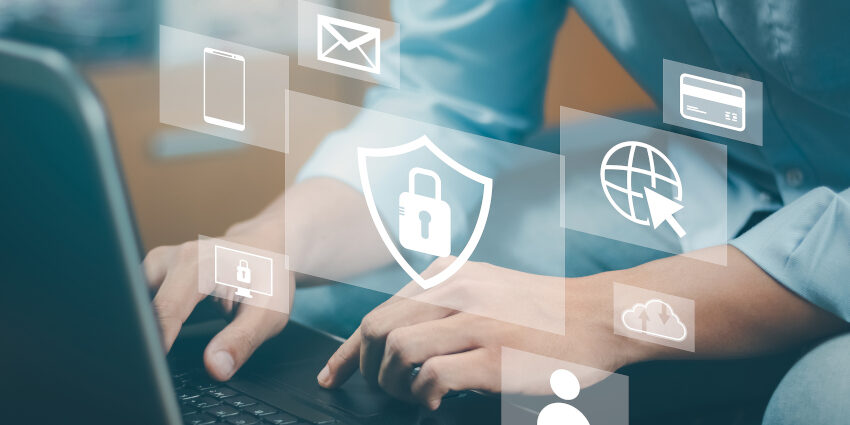 Person typing on a laptop keyboard; pop up icons representing email, mobile phones, security overlay