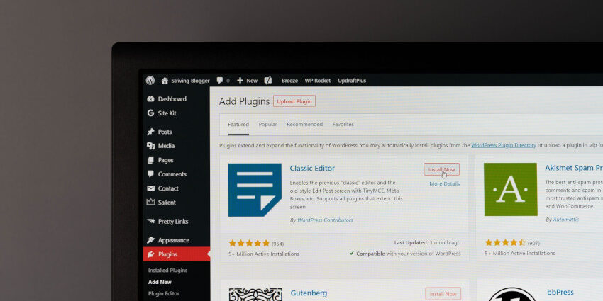 A computer screen shows the WordPress admin dashboard plugins section