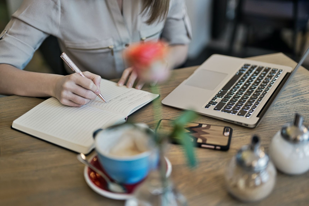 woman notetaking at desk