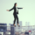 business woman walking on a high wire with tall city buildings in the background