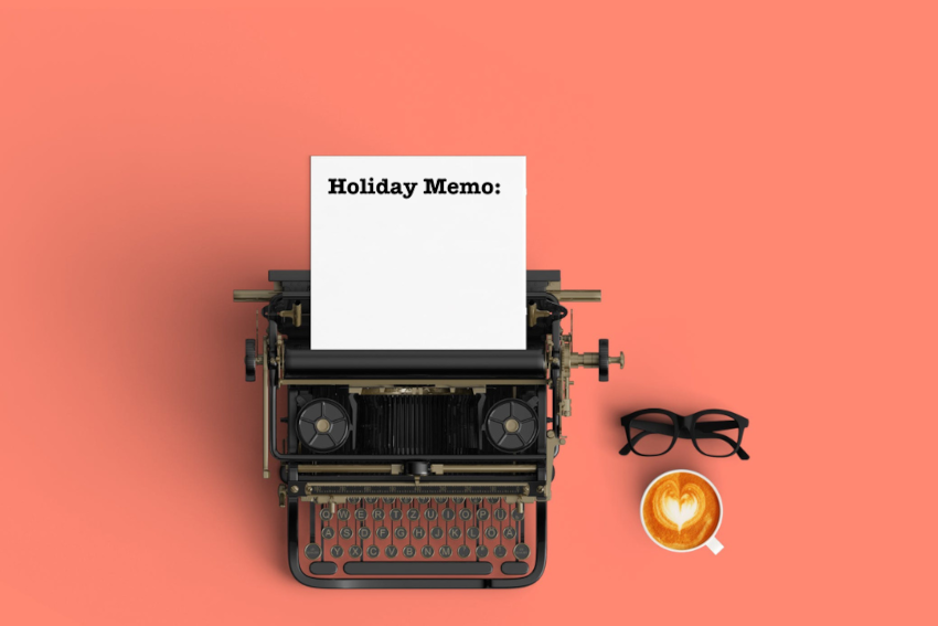 typewriter with paper sticking out of it; the paper reads Holiday Memo"