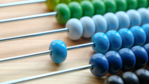 Close up on an abacus with beads in various shades of blues