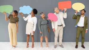 a diverse group of adults in business casual outfits, each one holding up a colorful speech bubble (each one has a different shape, size and color) to represent dei -diversity, equity, inclusion