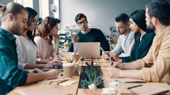 7 adults around conference table